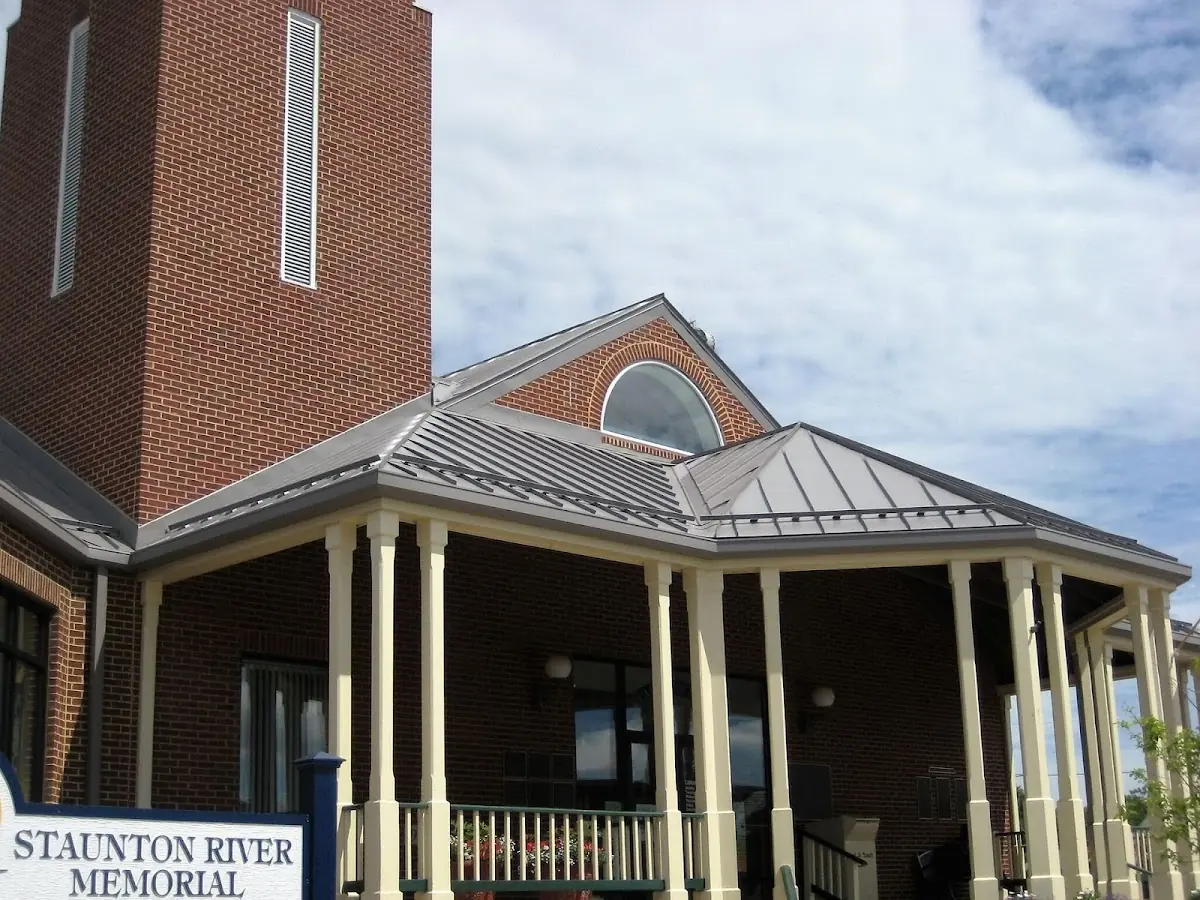 Skilled roofing craftsmen working on a residential roof in Arcanum